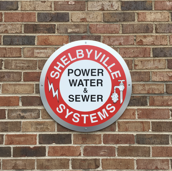 A photo of a wall with the Shelbyville Power and Water System logo